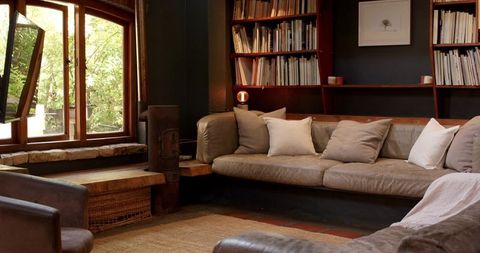 Cozy Living Room with Large Beige Sofa and Warm Decor