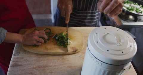 Senior Couple Cooking Together and Composting in Cozy Kitchen