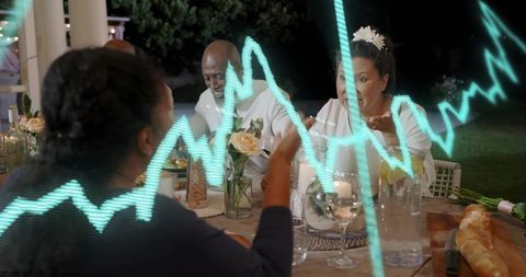 Friends enjoying backyard dinner with turquoise data wave overlay and candlelit table