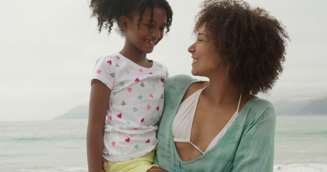 Smiling Mother with Daughter Enjoying Beach Time - Download Free Stock Images Pikwizard.com