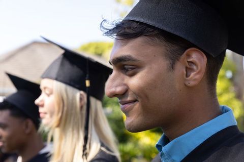 Diverse Graduates Celebrating Achievement in Outdoor Ceremony