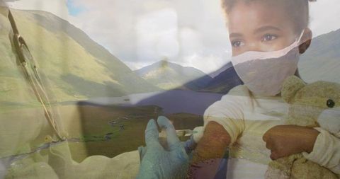 Masked child receiving vaccine while clutching teddy overlaid with mountain valley scene