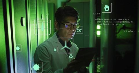 Korean engineer monitoring datacenter with tablet, green HUD overlays and sensor analytics