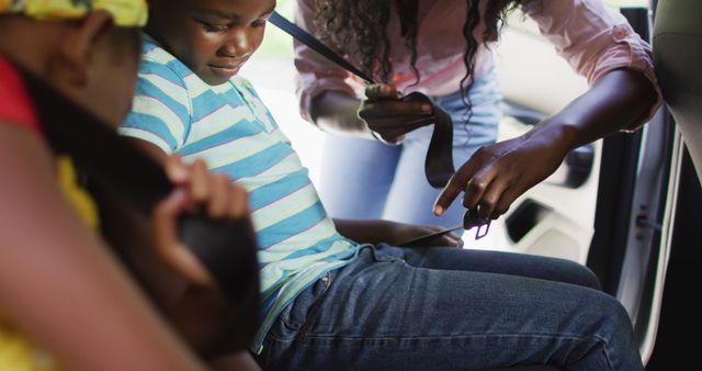 Black Mother Buckling Seatbelts for Two Young Children in Car - Download Free Stock Images Pikwizard.com