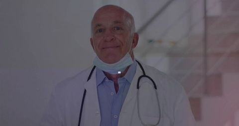 Experienced Doctor Standing in Hospital Corridor with Stethoscope