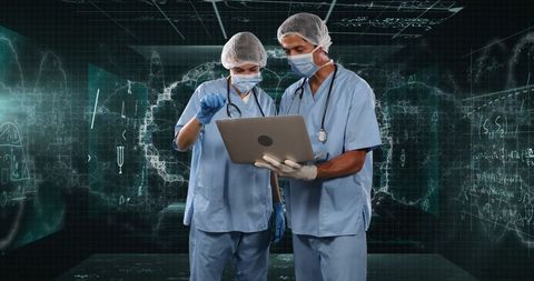 Surgeons utilizing technology amid digital medical data screens