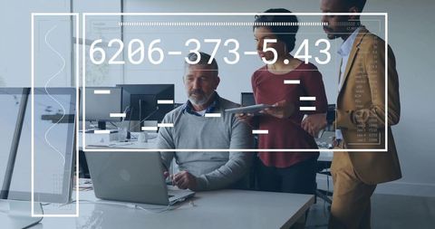 Collaborative team reviewing data on laptop with futuristic HUD overlay in modern office