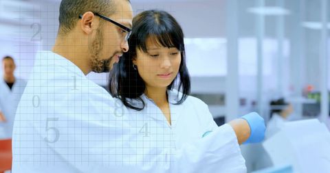 Diverse Scientists Collaborating on Data in Modern Laboratory