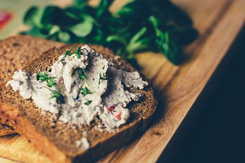 Creamy herbed chicken salad spread on toasted whole grain bread with fresh greens and herbs