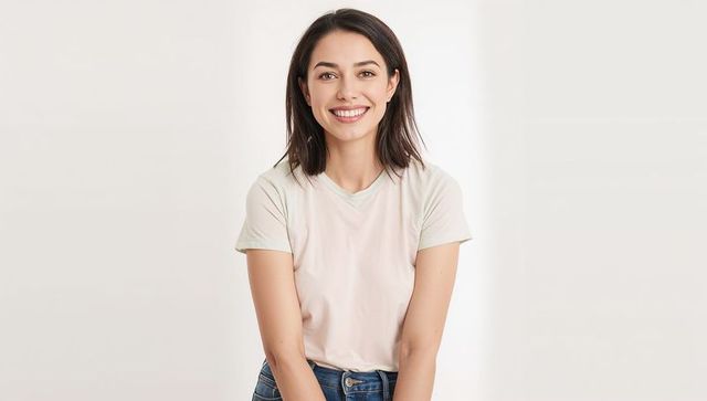 Smiling woman in studio wearing casual denim outfit