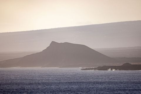 Mystical coastal mountain at dusk with calm beach