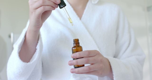 Person Applying Skincare Serum in Relaxing Spa Environment - Download Free Stock Images Pikwizard.com