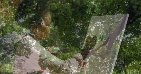 Woman artist painting in lush green garden setting