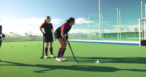 Diverse female teammates training on artificial turf field