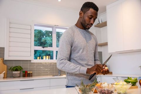 Man Preparing Fresh Ingredients in Modern Kitchen