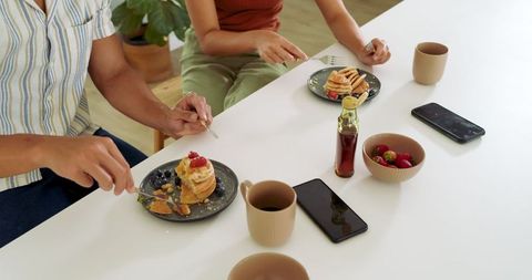Couple Enjoying Relaxed Morning Brunch with Pancakes at Home