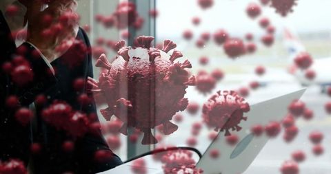 Business traveler with laptop amid digital virus simulation