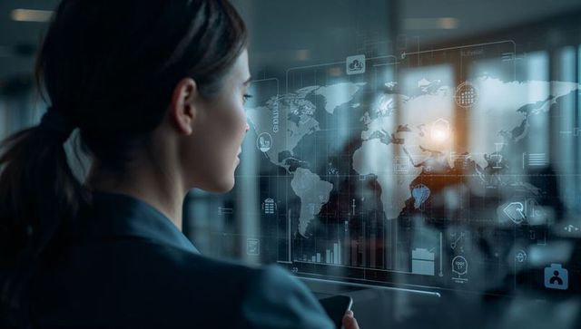 Businesswoman studying holographic global data visualization on office glass