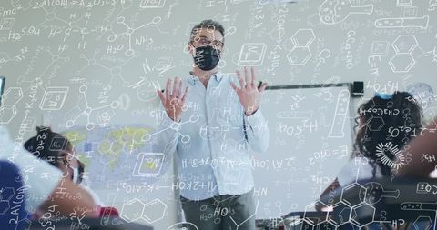 Chemistry Teacher Illustrating Complex Formulas to Students with Masks