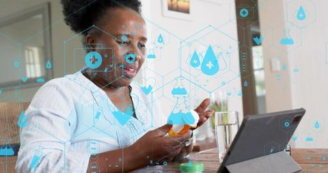 Female using tablet to manage medication with telehealth icons and remote healthcare