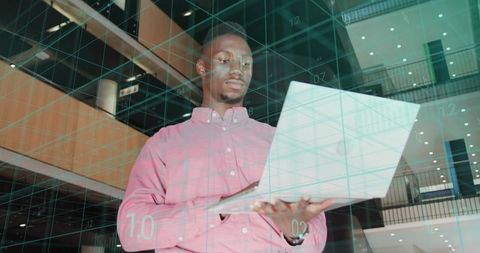 Business Professional Holding Laptop in Futuristic Tech Environment