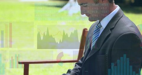 Executive working outdoors using laptop for financial analytics and data visualization