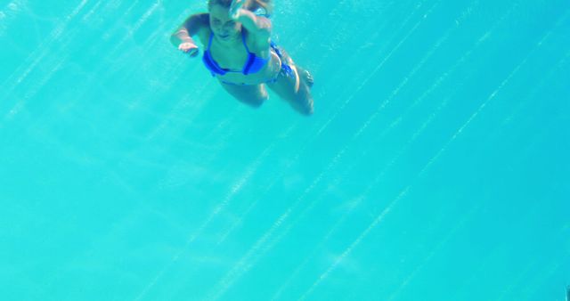 Woman Swimming Underwater in Clear Blue Ocean - Download Free Stock Images Pikwizard.com