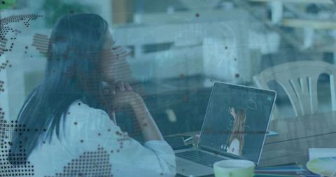 Businesswoman analyzing global data on laptop screen