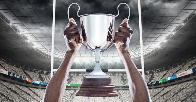 Athlete holding trophy in stadium, celebrating victory at sports event. Ideal for use in sports promotion, athletic achievement, sportsmanship, and advertisements related to competitive sports, team motivation, and success stories.