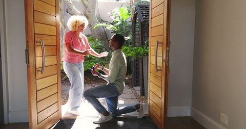 Man Proposing in Doorway Embracing and Smiling Joyfully