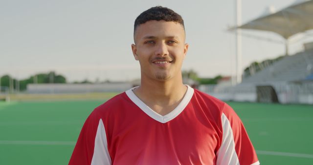 Young Athlete in Red Jersey Smiling at Sports Field - Download Free Stock Images Pikwizard.com