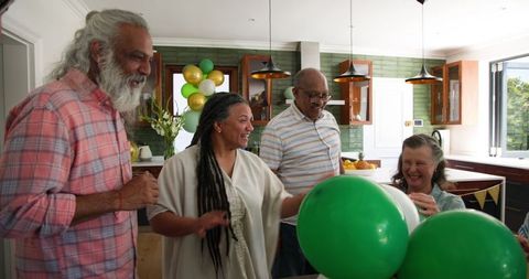 Joyful Senior Friends Decorating with Balloons for Celebration