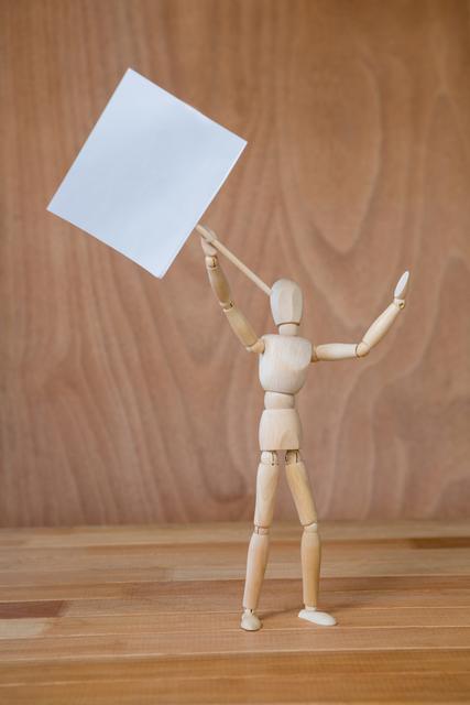 Conceptual image of figurine holding a signboard