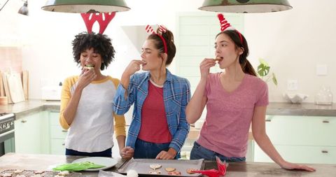 Diverse Friends Sampling Cookies During Festive Holiday Baking