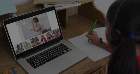 Girl Engaged in Online Learning on Laptop in Cozy Home Spot