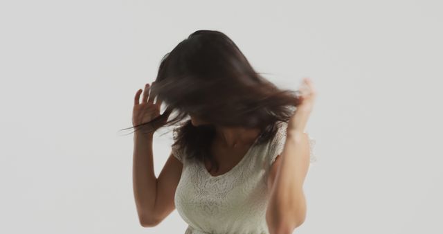 Woman Tossing Hair in a White Lace Dress on a Plain Background - Download Free Stock Images Pikwizard.com