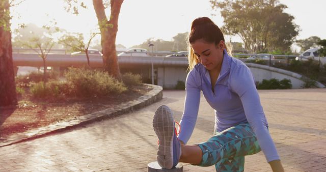 Woman Stretching Leg Doing Outdoor Exercise in Park at Sunset - Download Free Stock Images Pikwizard.com