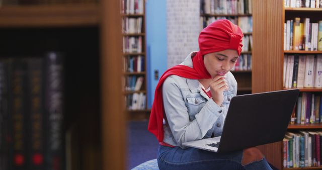 Young Muslim Woman in Library Studying with Laptop - Download Free Stock Images Pikwizard.com