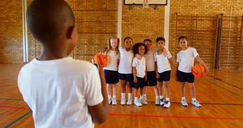 Diverse Schoolchildren Posing with Basketball in Court - Download Free Stock Images Pikwizard.com