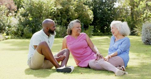 Senior Friends Enjoying Relaxing Conversation in Park