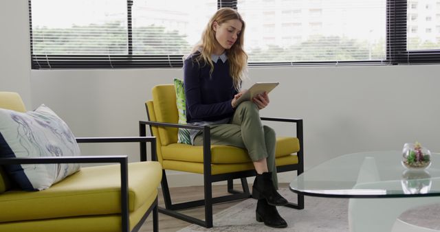 Young Woman Using Digital Tablet in Modern Office Lounge Area - Download Free Stock Images Pikwizard.com