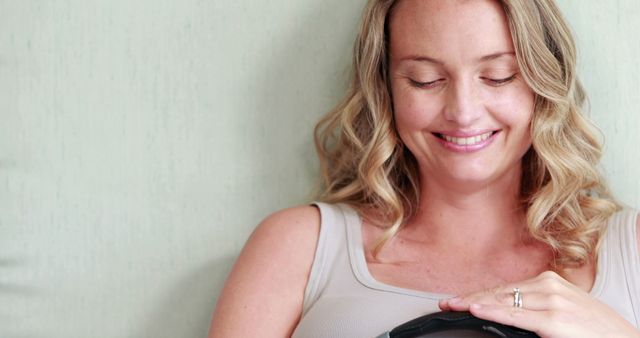 Pregnant Woman Smiling and Listening to Belly with Headphones - Download Free Stock Images Pikwizard.com