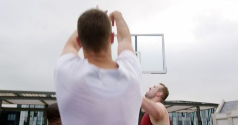 Diverse Group of Athletes Enjoying Basketball Game Outdoors