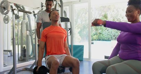 Young Adults Motivating Each Other During Gym Workout