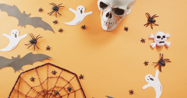 Close up of multiple halloween toys with copy space against orange background. halloween festivity and celebration concept