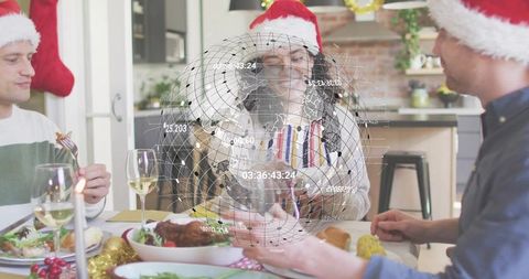 Smiling woman wearing santa hat at holiday dinner with holographic globe ar and friends