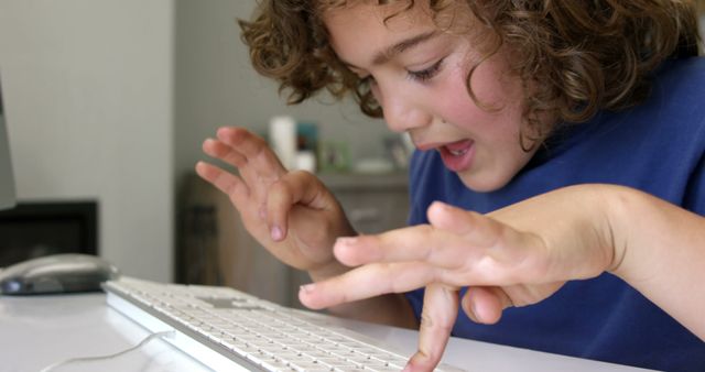Excited Child Typing on Computer Keyboard at Home - Download Free Stock Photos Pikwizard.com
