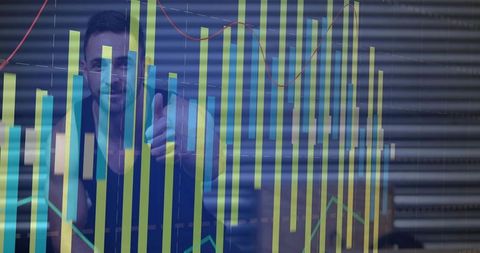Male analyst pointing through glass while colorful bar graph and line charts overlay