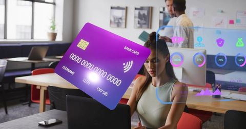 Floating holographic bank card hovering above laptop while professional working in office