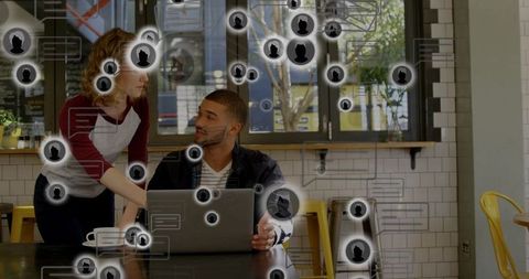 Collaborating at laptop in modern cafe with social network overlays and coworking vibe